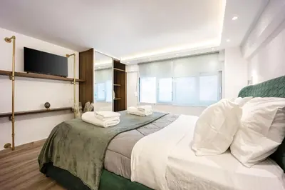 a bedroom with a large bed with towels on it at Loft 61 Charming renovated apartment with a loft! in Athens