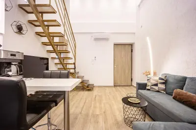a living room with a couch and a table at Loft 61 Charming renovated apartment with a loft! in Athens