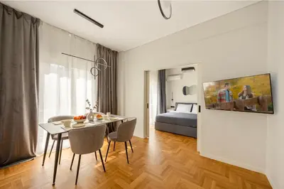 a living room with a table and chairs and a bed at Modern Designer Apartment in Athens Walk to Plaka & Acropolis in Athens