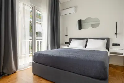 a bedroom with a bed and a large window at Modern Designer Apartment in Athens Walk to Plaka & Acropolis in Athens