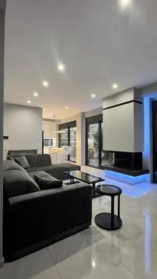a living room with a couch and a flat screen tv at Oliva luxury apartment in Athens