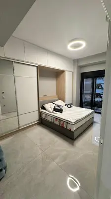 a bedroom with a bed in the middle of a room at Oliva luxury apartment in Athens