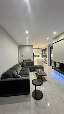 a living room with a couch and a tv at Oliva luxury apartment in Athens