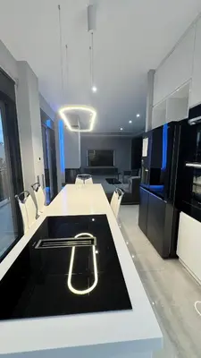 a kitchen with a white counter top with a handle on it at Oliva luxury apartment in Athens