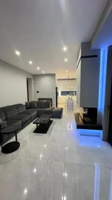 a living room with a couch and a flat screen tv at Oliva luxury apartment in Athens