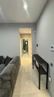 a living room with a couch and a table at Oliva luxury apartment in Athens