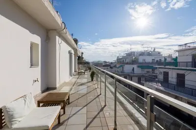 a balcony with benches on the side of a building at Acropolis & Lycabetus View Helios Residence in Athens