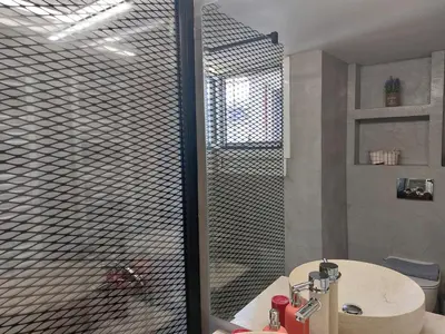 a bathroom with a shower with a glass door at Apartment with children's room in the city of Athens in Athens