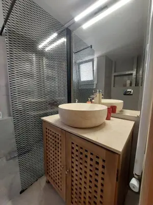 a bathroom with two sinks and a large mirror at Apartment with children's room in the city of Athens in Athens