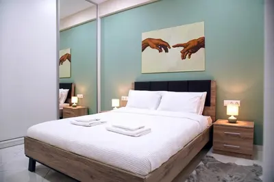 a bedroom with a bed with two towels on it at Aegean Modern Escape VIPGreece in Piraeus