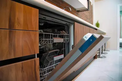 a kitchen with a dishwasher with dishes in it at Aegean Modern Escape VIPGreece in Piraeus