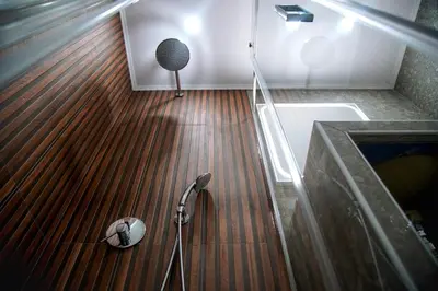 a bathroom with a shower and a wooden floor at Aegean Modern Escape VIPGreece in Piraeus