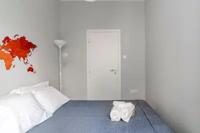 a bedroom with a bed with two towels on it at Athenian Entertainment & Relaxation Hub in Athens
