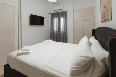 a bedroom with a large white bed with pillows at Amaltheia athens in Athens