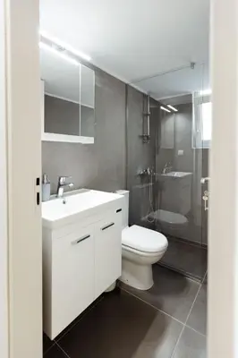 a bathroom with a white sink and a toilet at Amaltheia athens in Athens