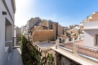 an apartment balcony with a view of buildings at Ofi the Fourth - 2-BR, Exarcheia in Athens