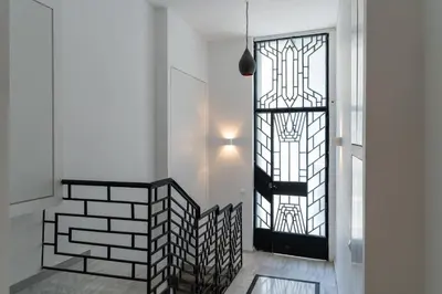 a hallway with a black door and a window at Ofi the Fourth - 2-BR, Exarcheia in Athens