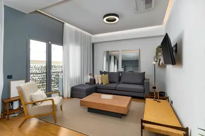 a living room with a couch and a table at Ofi the Fourth - 2-BR, Exarcheia in Athens
