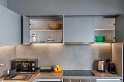 a kitchen with blue cabinets and oranges on the counter at Ofi the Fourth - 2-BR, Exarcheia in Athens