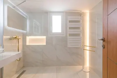 a white bathroom with a shower and a window at Acropolis & Lycabetus View Helios Residence in Athens