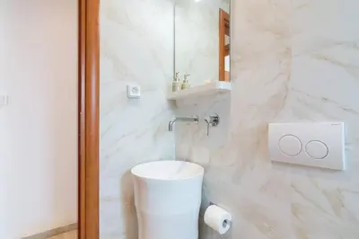 a white bathroom with a toilet and a sink at Acropolis & Lycabetus View Helios Residence in Athens