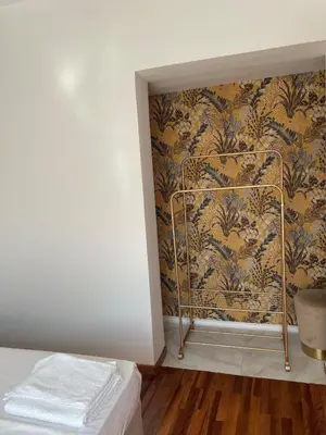 a bedroom with a wall with a wallpaper at Acropolis & Lycabetus View Helios Residence in Athens