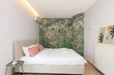 a bedroom with a bed with a floral wallpaper at Acropolis & Lycabetus View Helios Residence in Athens
