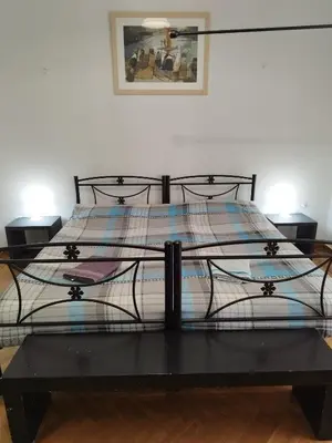 a bedroom with a bed with a black iron frame at Golden Hotel in Athens