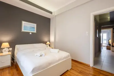 a bedroom with a bed with two towels on it at Cozy Hideaway Near the Acropolis in Athens