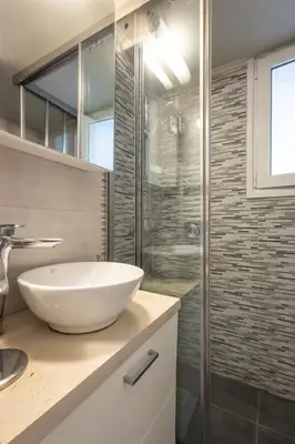 a bathroom with a sink and a glass shower at Cozy Hideaway Near the Acropolis in Athens