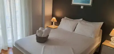 a bedroom with a white bed with a basket on it at Cozy Hideaway Near the Acropolis in Athens