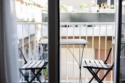 a table and two chairs sitting on a balcony at Cozy Hideaway Near the Acropolis in Athens