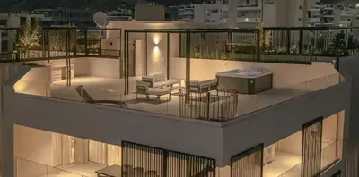 a balcony with a tub on the roof of a building at The Samirah Luxury Residences in Elliniko in Athens