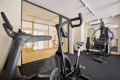 a gym with a treadmill and a bike at The Samirah Luxury Residences in Elliniko in Athens