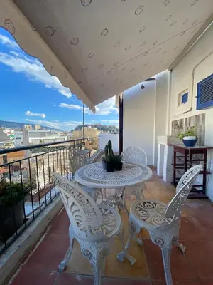 a patio with a table and chairs on a balcony at Mosaics Penthouse studio 360'View in Athens