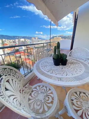 a table and chairs on a balcony with a view at Mosaics Penthouse studio 360'View in Athens