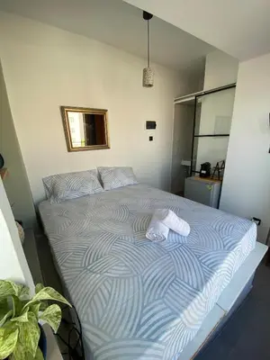 a bed with two towels on it in a room at Mosaics Penthouse studio 360'View in Athens