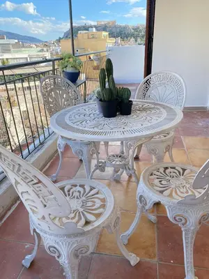a white table and chairs on a balcony at Mosaics Penthouse studio 360'View in Athens