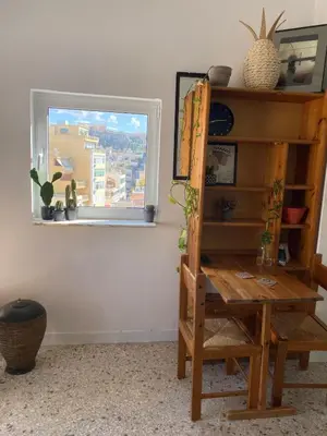 a room with a wooden table and a window at Mosaics easystay Penthouse 360'view in Athens