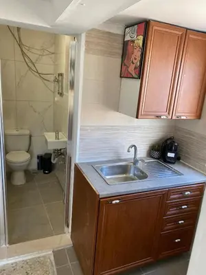 a small bathroom with a sink and a toilet at Mosaics easystay Penthouse 360'view in Athens