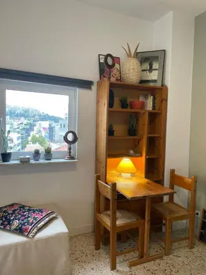 a room with a table and chairs and a window at Mosaics easystay Penthouse 360'view in Athens