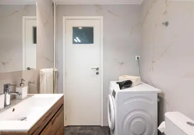 a white bathroom with a toilet and a sink at Urban Haven in Pagrati by MK in Athens
