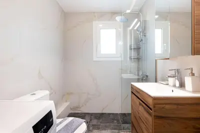a bathroom with a shower and a toilet and a sink at Urban Haven in Pagrati by MK in Athens