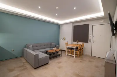 a living room with a couch and a table at Happy apartments 0 in Athens