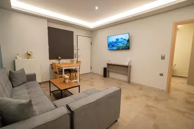 a living room with a couch and a table at Happy apartments 0 in Athens