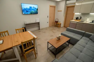 a living room with a couch and a table at Happy apartments 0 in Athens