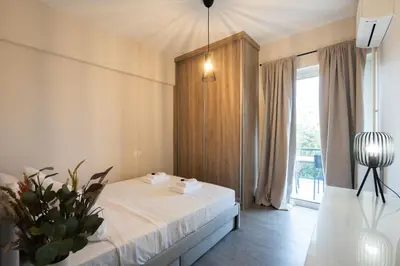 a bedroom with a bed and a large window at Relaxing Voula Hideaway in Athens
