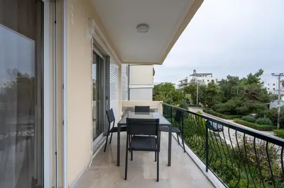 a balcony with a table and chairs on it at Relaxing Voula Hideaway in Athens