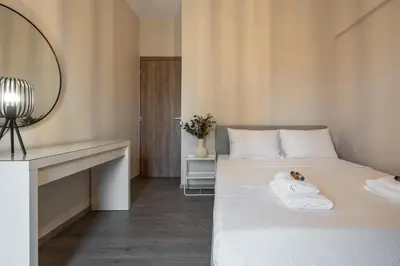 a bedroom with a bed with a vanity and a mirror at Relaxing Voula Hideaway in Athens