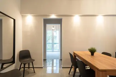 a dining room with a wooden table and chairs at Relaxing Voula Hideaway in Athens